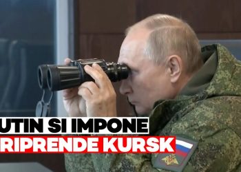 Vladimir Putin in tenuta militare guarda in un binocolo