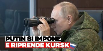 Vladimir Putin in tenuta militare guarda in un binocolo