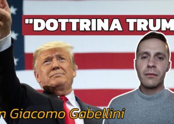 Donald Trump con una bandiera americana alle spalle. Giacomo Gabellini in primo piano