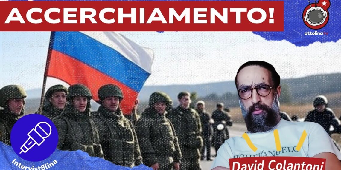 Soldati sotto una bandiera russa. David Colantoni in primo piano