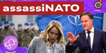 Esercito con bandiera NATO. Giorgia Meloni e Mark Rutte in primo piano