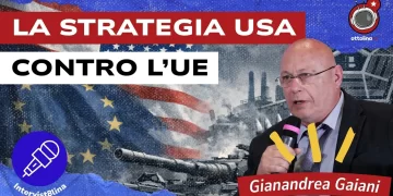 Bandiere USA e Ue. Una portaerei. Gianandrea Gaiani in primo piano