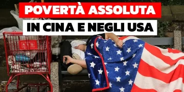 Persona che vive in strada intento a dormire avvolto nella bandiera USA