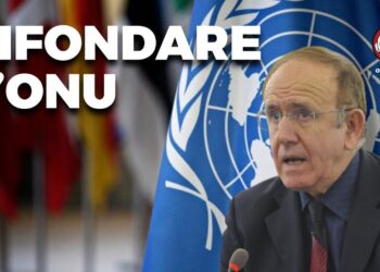 Pino Arlacchi con alle spalle la bandiera delle Nazioni Unite
